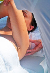 massaging shoulder joint stretched
